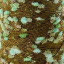 Close-up of a variegated yarn skein featuring a dark olive brown base with fluffy, fuzzy accents in mint green, light beige, and light brown.