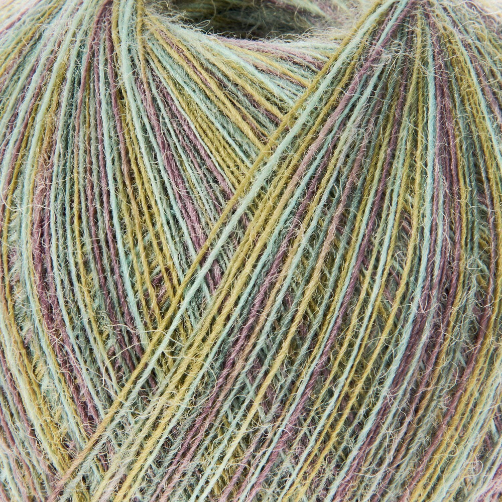 Close-up of a ball of fuzzy yarn with variegated strands in pale green, mustard yellow, dusty pink, and taupe.