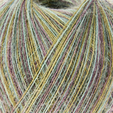 Close-up of a ball of fuzzy yarn with variegated strands in pale green, mustard yellow, dusty pink, and taupe.
