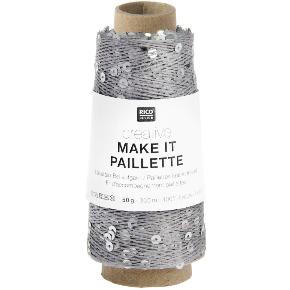 A spool of silver thread with attached sequins, wrapped in a white paper label that reads 'RICO DESIGN creative MAKE IT PAILLETTE'.