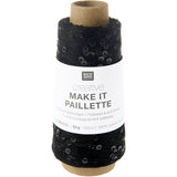 A spool of black knitted thread labeled 'RICO DESIGN creative MAKE IT PAILLETTE' on a white background.