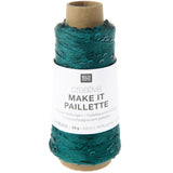 A spool of Rico Design creative Make It Pailleçte thread in a deep teal green color, wound on a brown cardboard core with a white paper label.