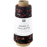 A spool of Rico Design Creative Make It Paillette thread, featuring black and red sequined thread wound around a cardboard core with a white paper label.