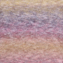 A close-up of a knitted fabric with a soft gradient pattern blending pastel yellow, lavender, pink, and peach tones.