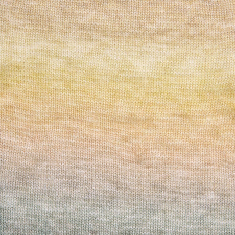 A close-up of a knitted fabric with a soft ombre gradient transitioning from pale yellow at the top through warm beige to light gray at the bottom.