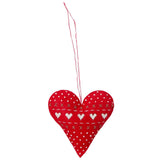 A red heart-shaped fabric hanging ornament with white embroidered hearts, dots, and stitched lines, suspended by a thin red string against a plain white background.