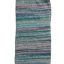A rectangular area rug with a soft, plush texture featuring horizontal stripes in shades of teal, blue, purple, and gray on a white background.