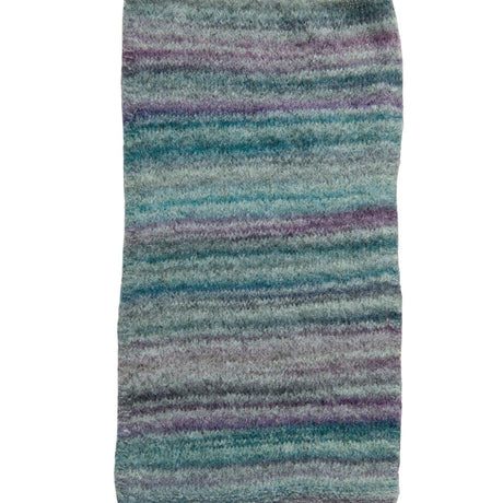 A rectangular area rug with a soft, plush texture featuring horizontal stripes in shades of teal, blue, purple, and gray on a white background.