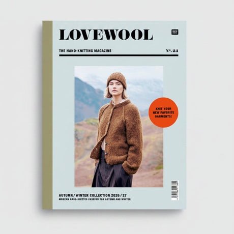 Front cover of LOVEWOOL magazine, issue 23, featuring a model wearing a brown fuzzy knit cardigan and matching beanie outdoors. The cover has a pale blue-green background with black text and a bright orange circular callout.