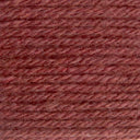 A close-up texture shot of twisted yarn in a dusty rose or mauve-brown color, filling the entire frame.