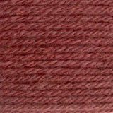 A close-up texture shot of twisted yarn in a dusty rose or mauve-brown color, filling the entire frame.