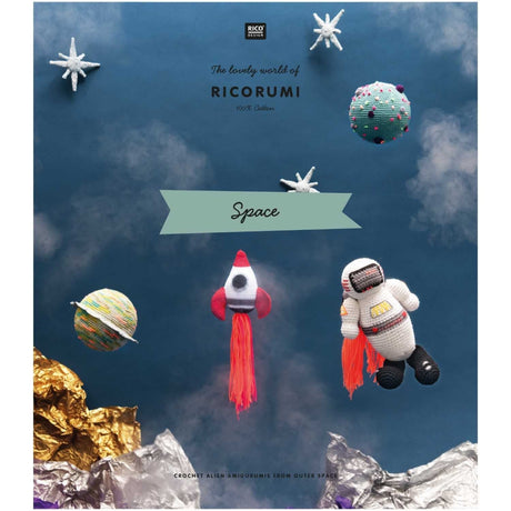 Crocheted space-themed items including an astronaut and rocket ship against a space-themed background with planets and stars.