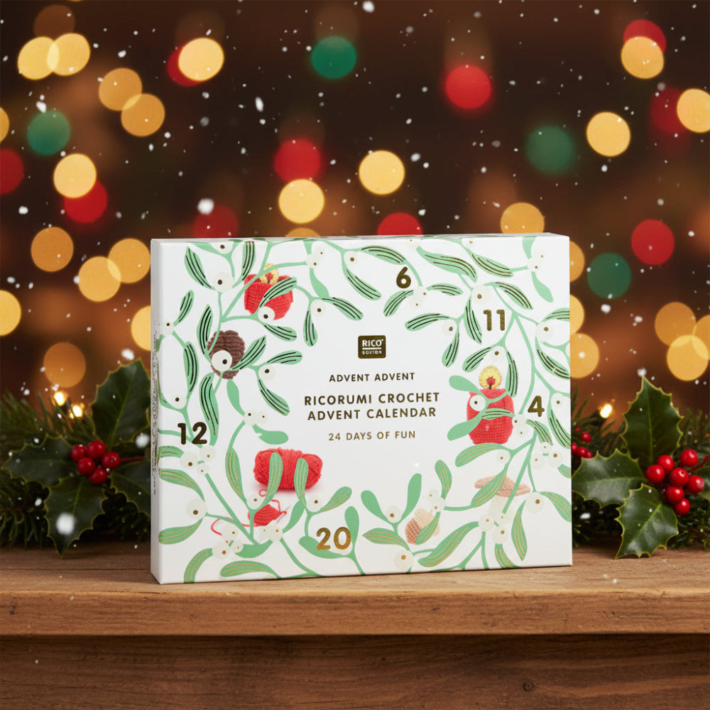Rico Design Advent Advent 'Ricorumi Crochet' calendar box, featuring a white background decorated with green leafy vines, red yarn balls, crochet hooks, and gold advent numbers 1 through 24.