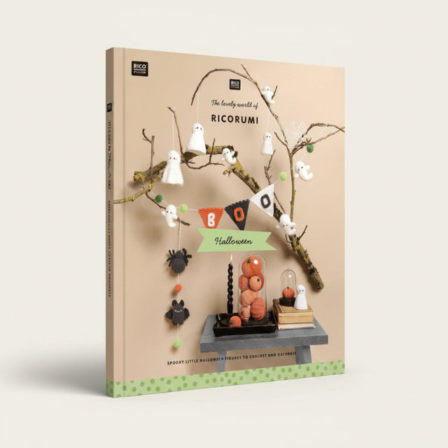 A styled product photo for a crochet and decor kit titled 'The lovely world of RICORUMI' featuring Halloween-themed crocheted ghost figures, a black spider, orange pumpkin decorations, a black candle, and a small table setup against a beige background with decorative branches.