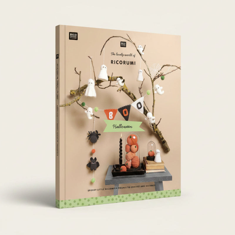 A styled product photo for a crochet and decor kit titled 'The lovely world of RICORUMI' featuring Halloween-themed crocheted ghost figures, a black spider, orange pumpkin decorations, a black candle, and a small table setup against a beige background with decorative branches.