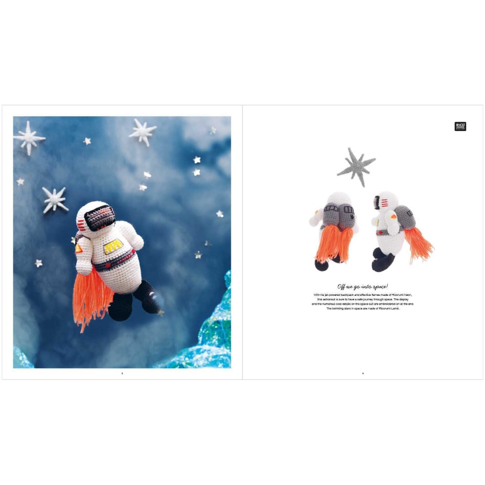 Crocheted astronaut toy with orange space suit against a blue sky with stars background