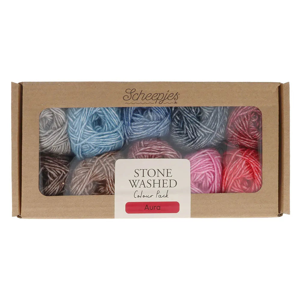 Box of Scheepjes stone washed Aura yarn with colourful skeins on a white background