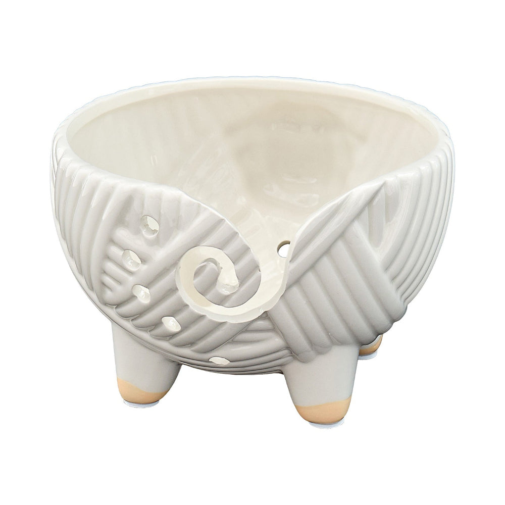 White ceramic planter with textured design on a white background