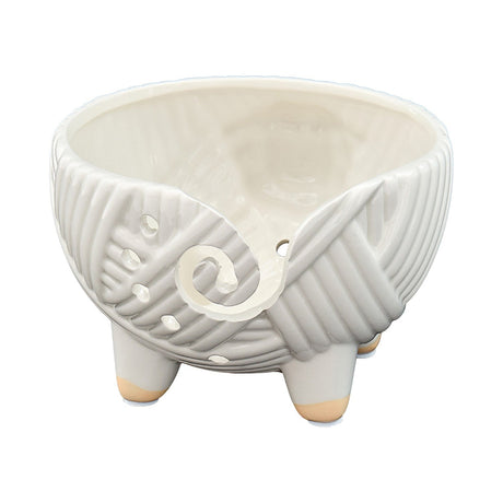 White ceramic planter with textured design on a white background