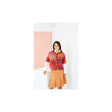A woman modeling a colourful striped knit cardigan with buttons over a white long-sleeve shirt and a tan pleated skirt, standing in a minimalist studio setting with white walls and a soft pink accent panel.