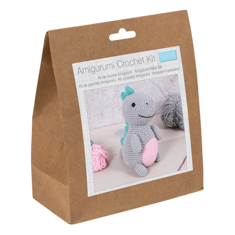 Amigurumi crochet kit packaging with a picture of a crocheted dinosaur on a white background