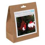 A brown kraft paper bag package labeled 'Amigurumi Crochet Kit' with a photo of crocheted Christmas ornaments on the front, photographed on a white background.