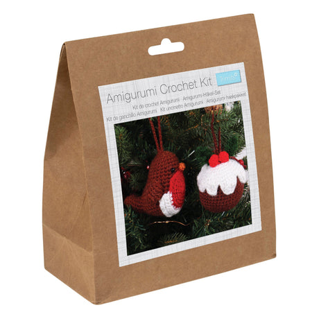 A brown kraft paper bag package labeled 'Amigurumi Crochet Kit' with a photo of crocheted Christmas ornaments on the front, photographed on a white background.
