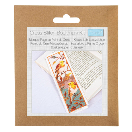 A cross stitch bookmark kit in its original brown kraft paper packaging, featuring a printed insert that shows a completed bookmark with a bird pattern.