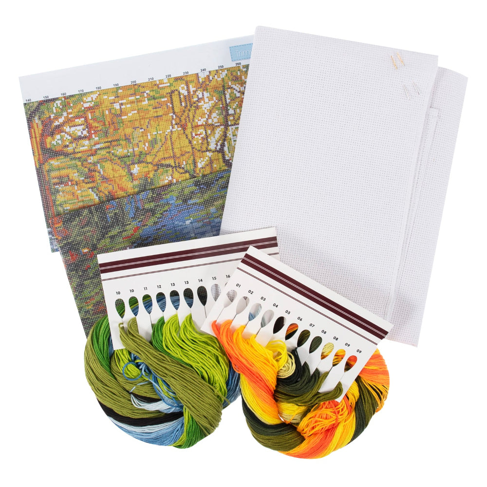 A needlework kit laid out on a white background, including a printed pattern sheet, white fabric canvases, two skeins of multicolored thread, and a card showing colour samples.