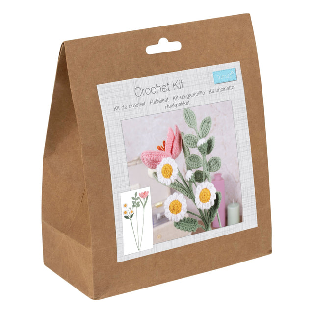 Crochet kit packaging with floral designs on a white background