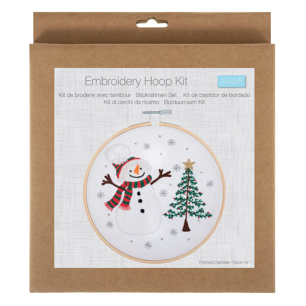 Embroidery Hoop Kit in its original brown kraft paper packaging, featuring a festive snowman and Christmas tree design on the front label.