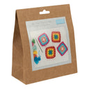 Crochet kit packaging with colourful granny squares on a white background