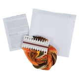 Cross stitch kit with a bundle of multicolour embroidery floss, a white grid canvas, an instruction booklet, and a colour chart on a white background.