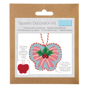 Trimits Tapestry Decoration Kit in its original brown kraft paper packaging, featuring a heart-shaped tapestry design with pink and blue sections, green holly leaves, and red stitching details.