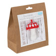 Crochet kit packaging with a picture of a crocheted mushroom on a white background