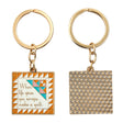 Two keychains with geometric designs and text on a white background