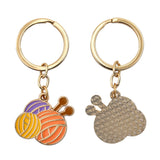 Two keychains with knitting-themed charms on a white background