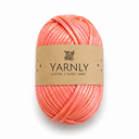 A ball of coral pink glittery t-shirt yarn with a brown paper label reading 'YARNLY LUSTRE T-SHIRT YARN' on a white background.