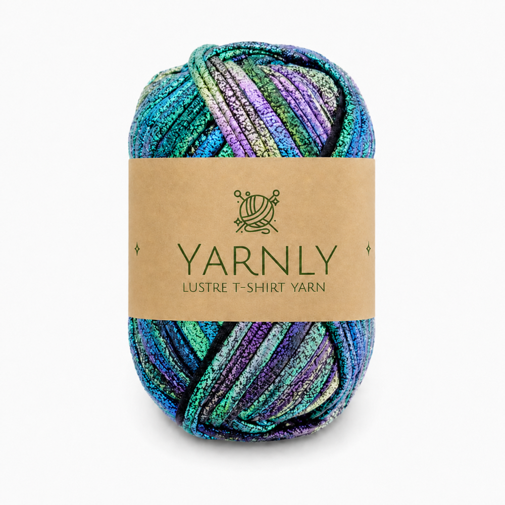 A skein of Yarnly Lustre T-Shirt Yarn with a brown paper label, featuring variegated colors of teal, green, purple, and blue with a shimmering finish, set against a plain white background.