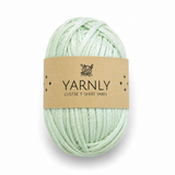 A ball of pale mint green yarn wrapped with a brown paper label that reads 'YARNLY LUSTRE T-SHIRT YARN' on a white background.