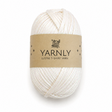 A skein of Yarnly Lustre T-Shirt Yarn in a warm off-white/cream color, wrapped in a brown kraft paper label, on a clean white background.