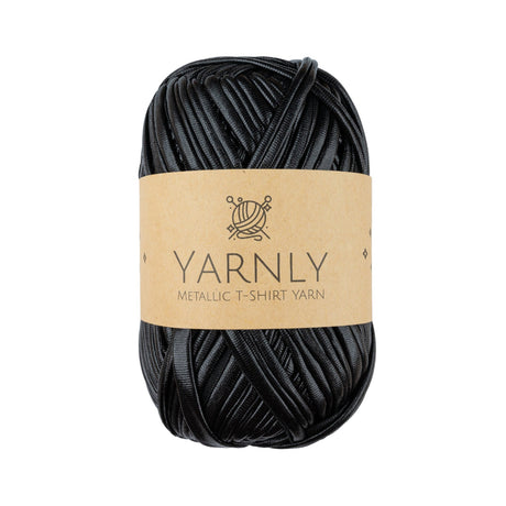 A skein of black metallic t-shirt yarn wrapped in a light brown paper band labeled 'YARNLY METALLIC T-SHIRT YARN' on a plain white background.
