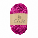 A skein of metallic fuchsia pink yarn with a brown paper label reading 'YARNLY METALLIC T-SHIRT YARN' on a plain white background.