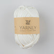 Ball of white yarn with a brown label on a white background